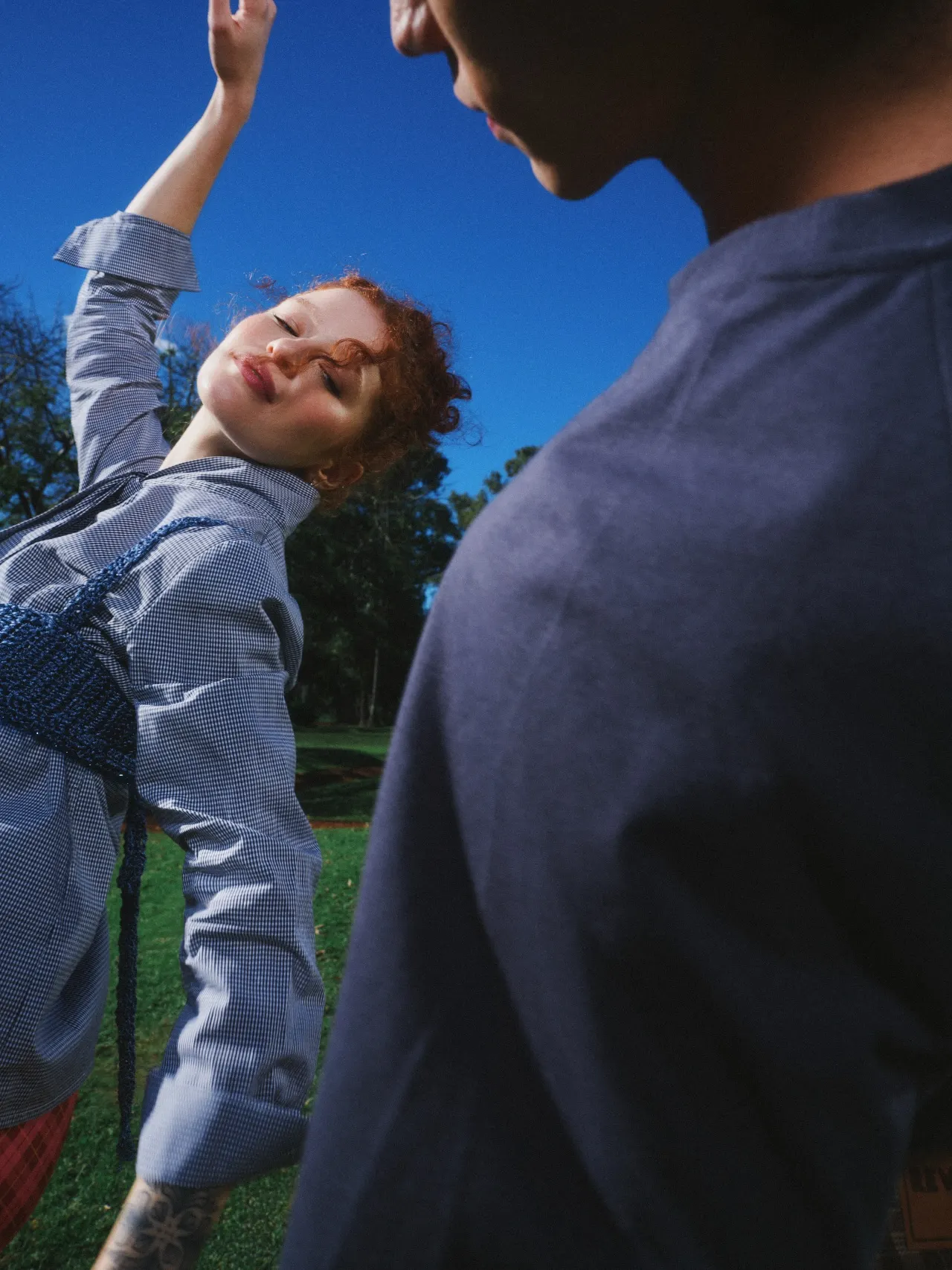 A woman reaching her arm towards the sky